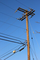 Electric poles made of wood against a dark blue sky scene. in America