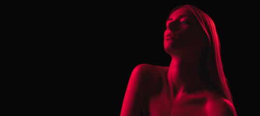 Monochrome. Dark red night. Young sensual woman in neon light on dark background. Cyberpunk style,...