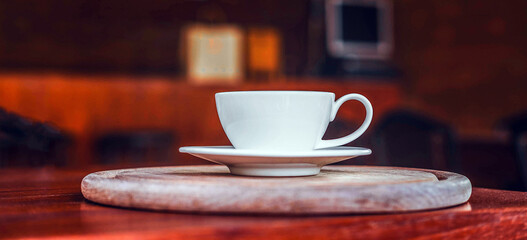 A cup of coffee on wooden table in coffee shop