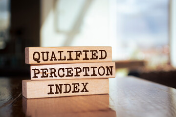 Wooden blocks with words 'Qualified Perception Index'. Business concept