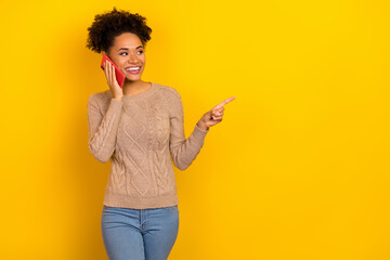 Photo of cute millennial brunette lady talk telephone look promo wear beige pullover isolated on yellow color background