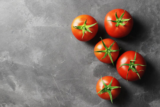 Fresh ripe tomatoes on a concrete background. Top view. View from above.