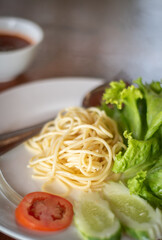 Spaghetti Pasta and tomato sauce Garlic and spices with cheese and fork in a lettuce platter