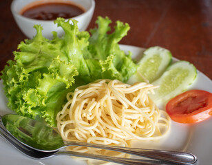 Spaghetti Pasta and tomato sauce Garlic and spices with cheese and fork in a lettuce platter