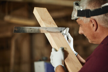 carpenter in a carpentry workshop makes products, furniture production concept