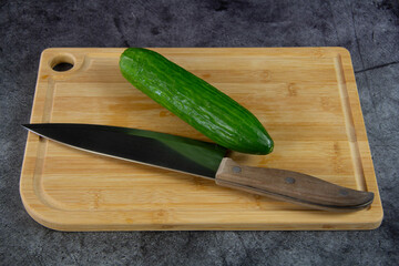 Green cucumbers on a cutting board