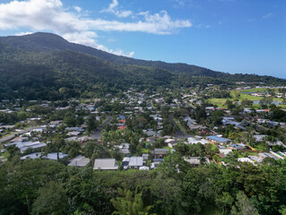 Fototapeta na wymiar Aerial photo of tropical housing estate in a mountain range