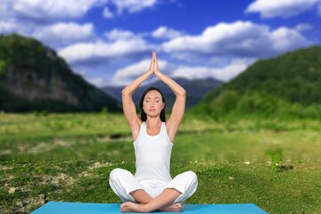 Beautiful woman doing yoga relaxed in the park