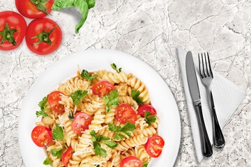 Italian pasta dish with cheese, tomato and fresh vegetables.