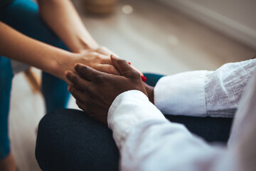 Shot of two people holding hands in comfort. I'm here for you. Closeup shot of two unrecognizable people holding hands in comfort.