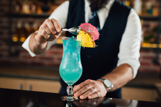 close up of barman decorate blue lagoon cocktail