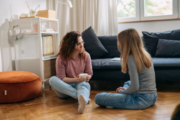 mother and daughter talking in living room