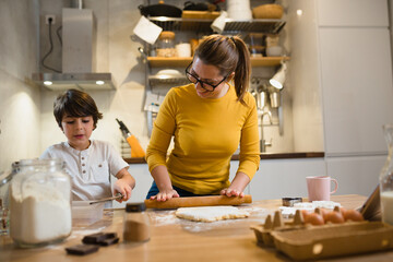 mother and her son preparing cookies for holidays