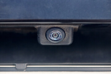 Luxury back car rear view camera close up for parking assistance in macro. Concept of safety car driving while parking process. Assist device equipment in modern cars