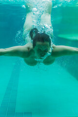 Young woman in the pool underwater, underwater shooting
