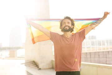 Happy man with a pride flag. LGBT community.