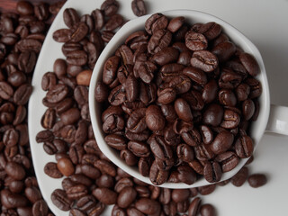 Coffee cup and coffee beans on a wooden background. View from above.