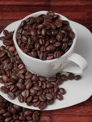 Coffee cup and coffee beans on a wooden background. View from above.