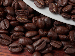 Coffee cup and coffee beans on a wooden background. View from above.