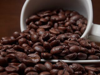Coffee cup and coffee beans on a wooden background. View from above.