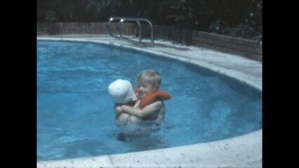 Pool Playtime 1969 - A girl plays with her younger siblings in a pool in Canoga Park, Californai in 1969. 