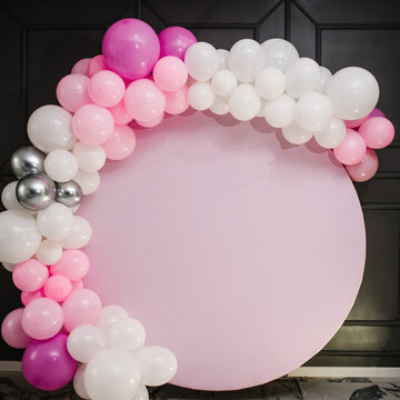 Arch decorated with pink, white, and silver balloons for the wedding ceremony. Celebration concept. Trendy decor and photo wall. Copy space. A place for text.
