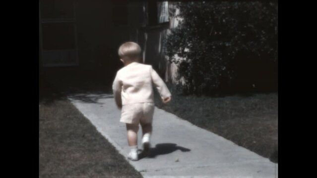 Ready to Leave 1966 - A toddler in his Easter suit walks around the yard and is ready to leave in Canoga Park, California in 1966.