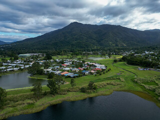 Aerial photo of lake with a mountain backdrop and cloudy sky