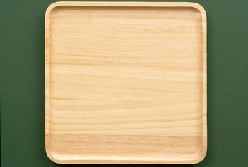 top view flat lay square natural wooden plate texture on dark green with copy space background.concept for organic food  wallpaper,dessert backdrop.