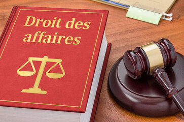 A law book with a gavel - Business law in french - Droit des affaires - obrazy, fototapety, plakaty