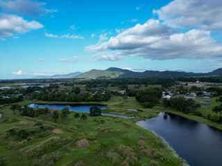 Aerial view of a lake a mountains with blue and cloudy sky