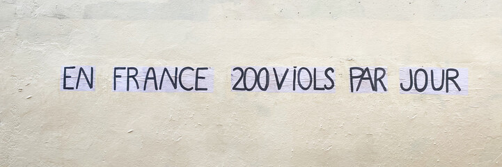 Protest poster against violence over women and rape, stuck on a door saying "In France 200 rapes per day"