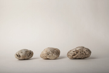 group of three pebbles on neutral background