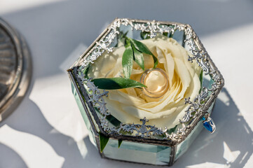Glass box with rose head inside as wedding ring luxury holder