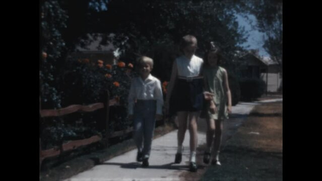 Sunday Best 1971  - Siblings wear their Sunday best as they walk down the sidewalk together and with their parents in Canoga Park, California in 1971.