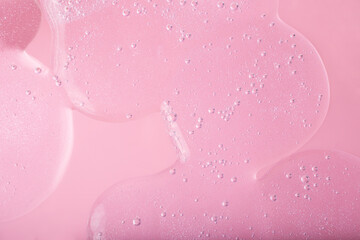 Macro photography of bubbly smear on raspberry pink background,large banner.