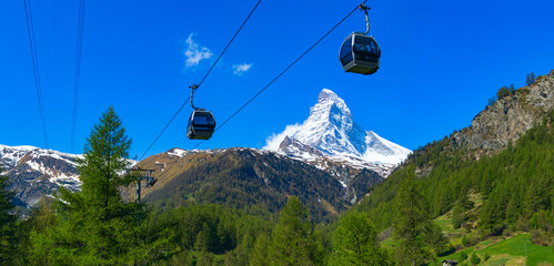 Scenic panoramic view of the Matterhorn and the cable car with cabins against the blue sky