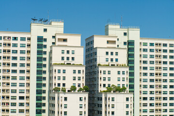 Fototapeta na wymiar Construction site high rise building with crane against blue sky
