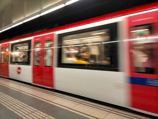 Wide angle view of an electric train accelerating with motion blur in a metro station in Barcelona,...