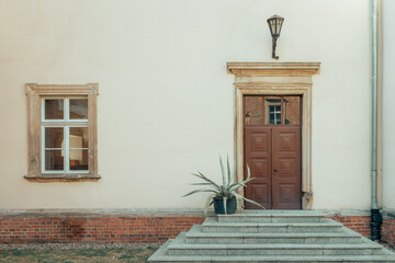 frontal view of the doors and stairs on the facade of an ancient building
