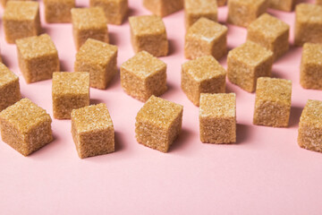 Cane sugar on a pink background. Brown refined cane sugar.	