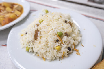 Delicious rice with garniture, raisins pea and sweet corn in rice, dinner and meal idea, eating Turkish food, top view of pilaff, selective focus