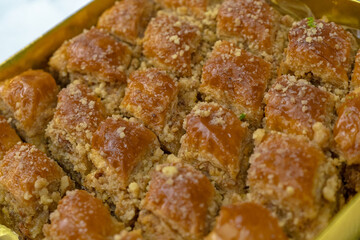 Homemade baklava with syrup and walnuts. Side view
