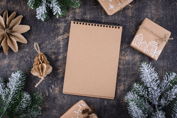 Christmas composition with empty craft notebook