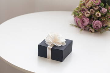 Small black jewelry box on white tabel.