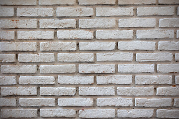 Front view and close up shot of concrete and with stack and row of brick wall shows pattern and grunge texture of old and vintage building. It is beautiful background and backdrop for loft design.