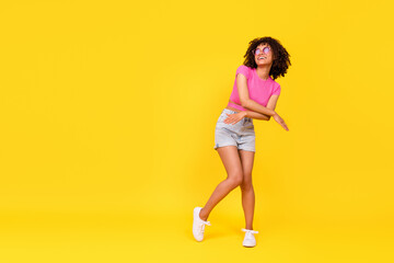 Fototapeta na wymiar Full size photo of overjoyed positive lady have fun dancing chilling isolated on yellow color background