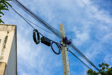 A roll of fiber-optic cables is suspended from a pole. High-speed internet communication optical...