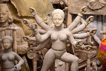 Sculpture of Hindu Goddess Durga. Goddess idols are being prepared with clay before festival. Idols being made for Durga Puja festival. Sculpture of goddess durga.