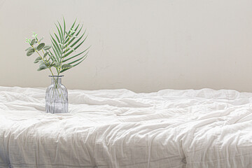 a small glass vase on bed